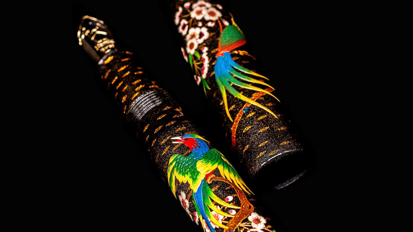 Namiki Emperor Rakucho Bird fountain pen showcasing intricate Maki-e artwork of a colorful bird and cherry blossoms on a black Urushi lacquer body