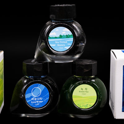 An overhead view of 3 colorverse spcial edition series ink bottles and 2 boxes, 1 to each side.