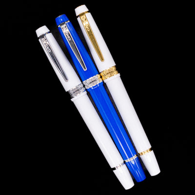 An overhead view of 3 Cross fountain pens capped.