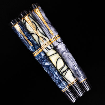An overhead view of 3 Parker fountain pens capped.