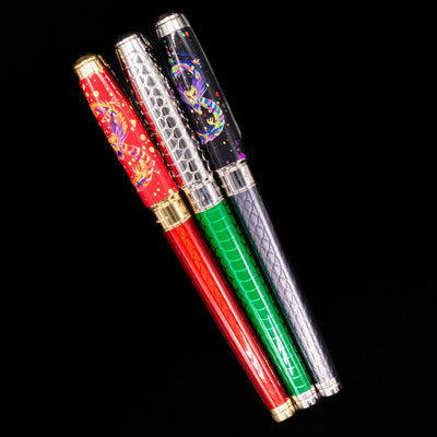 An overhead view of 3 ST Dupont fountain pens capped.