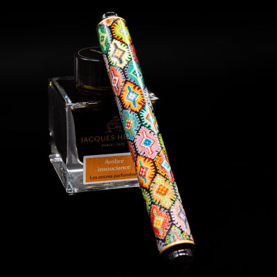 AP Limited Editions Imperial Lacquer Art Fountain Pen - Tutankhamen capped, leaning against an ink bottle. 