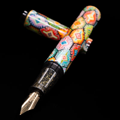 AP Limited Editions Imperial Lacquer Art Fountain Pen - Tutankhamen laying across its own cap, crossed, with a focus on the nib.