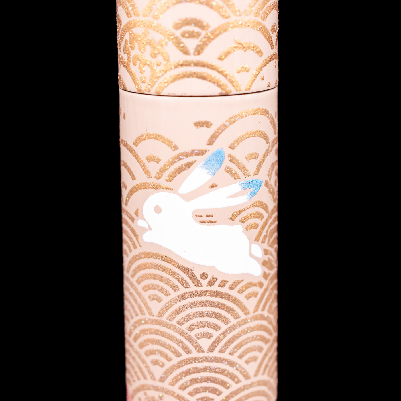 A detail shot of a blue-eared bunny on the AP Limited Editions Sakura Lacquer Art Fountain Pen - Rabbits in a Summer Garden.