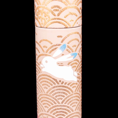 A detail shot of a blue-eared bunny on the AP Limited Editions Sakura Lacquer Art Fountain Pen - Rabbits in a Summer Garden.