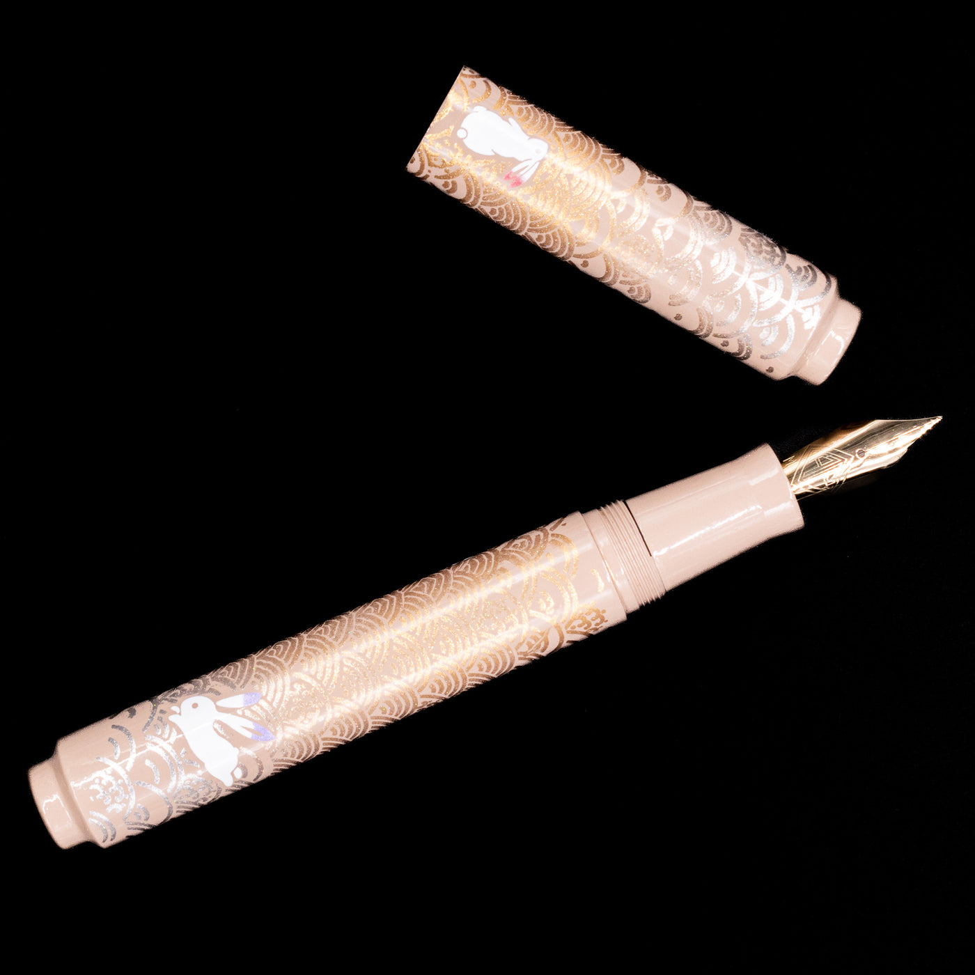 An overhead view of the AP Limited Editions Sakura Lacquer Art Fountain Pen - Rabbits in a Summer Garden uncapped.