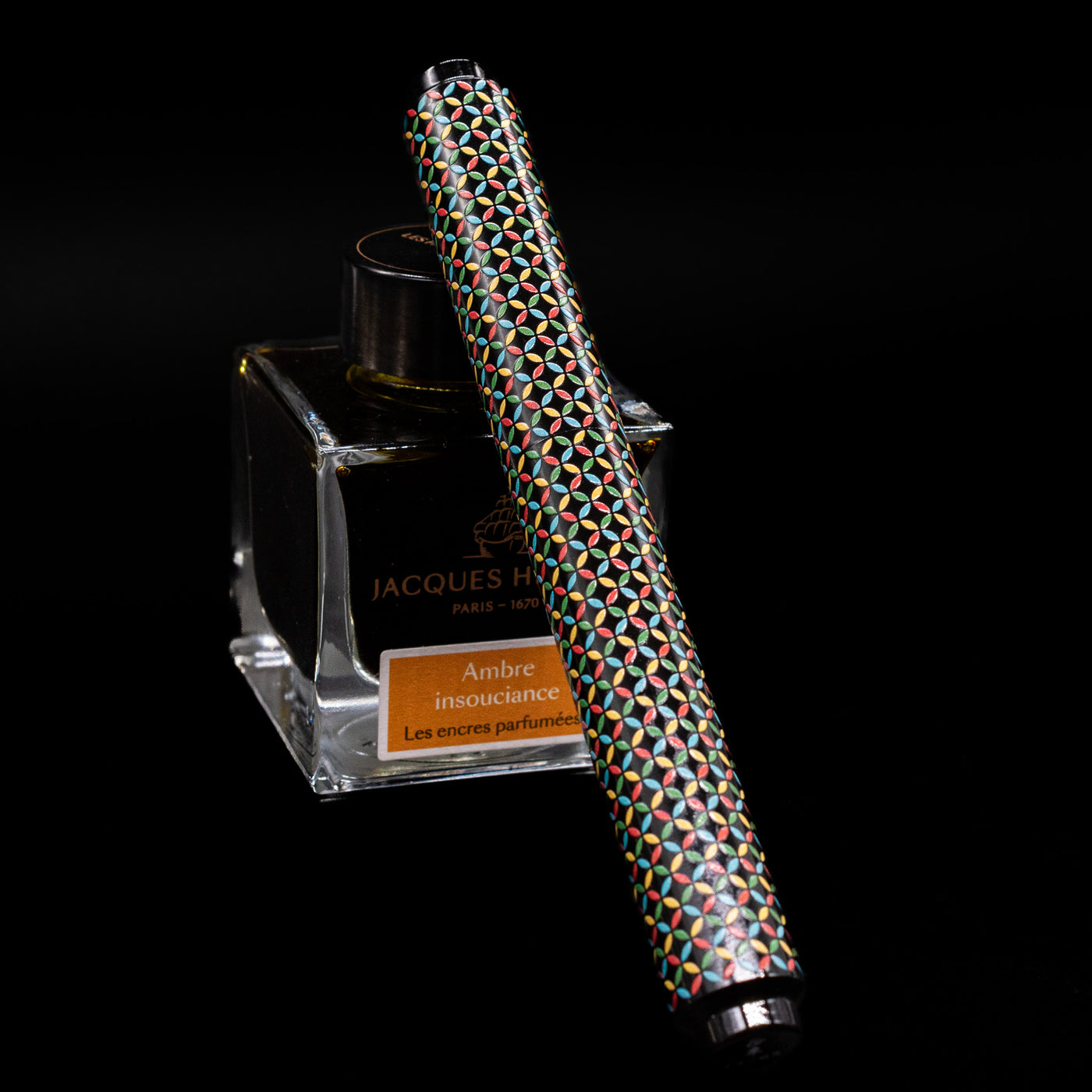 AP Limited Editions Sakura Lacquer Art Fountain Pen - Rhythm capped, leaning against an ink bottle. 