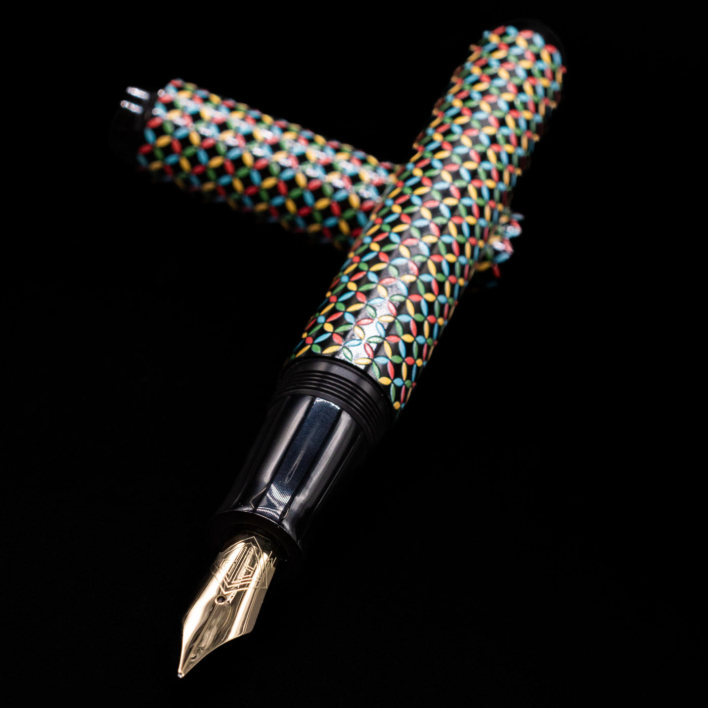 AP Limited Editions Sakura Lacquer Art Fountain Pen - Rhythm laying across its own cap, crossed, with a focus on the nib.