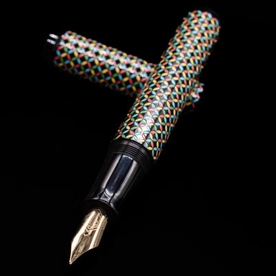 AP Limited Editions Sakura Lacquer Art Fountain Pen - Rhythm laying across its own cap, crossed, with a focus on the nib.