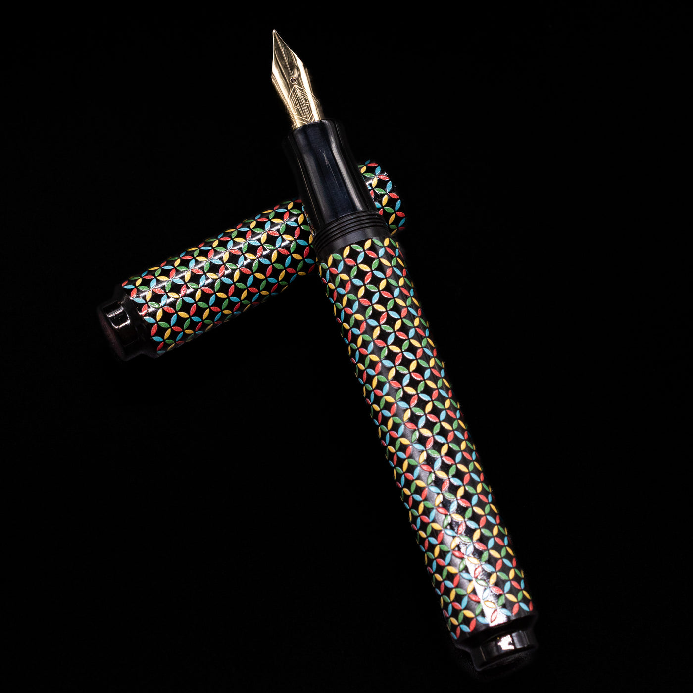 AP Limited Editions Sakura Lacquer Art Fountain Pen - Rhythm laying on top of its cap in a crossed position showing full view of the entire uncapped pen.