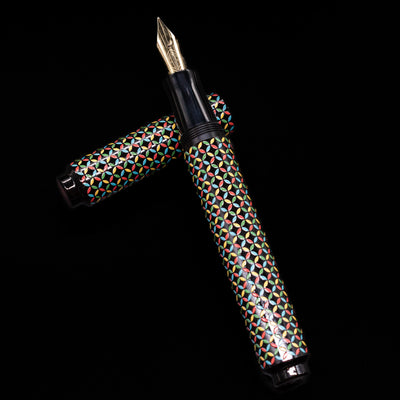 AP Limited Editions Sakura Lacquer Art Fountain Pen - Rhythm laying on top of its cap in a crossed position showing full view of the entire uncapped pen.