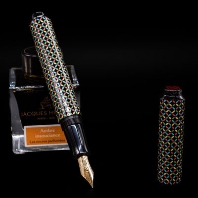 AP Limited Editions Sakura Lacquer Art Fountain Pen - Rhythm leaning on an ink bottle uncapped showcasing the detailing on the nib.