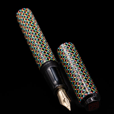 A full view of the AP Limited Editions Sakura Lacquer Art Fountain Pen - Rhythm uncapped, with its cap laying next to the pen. 