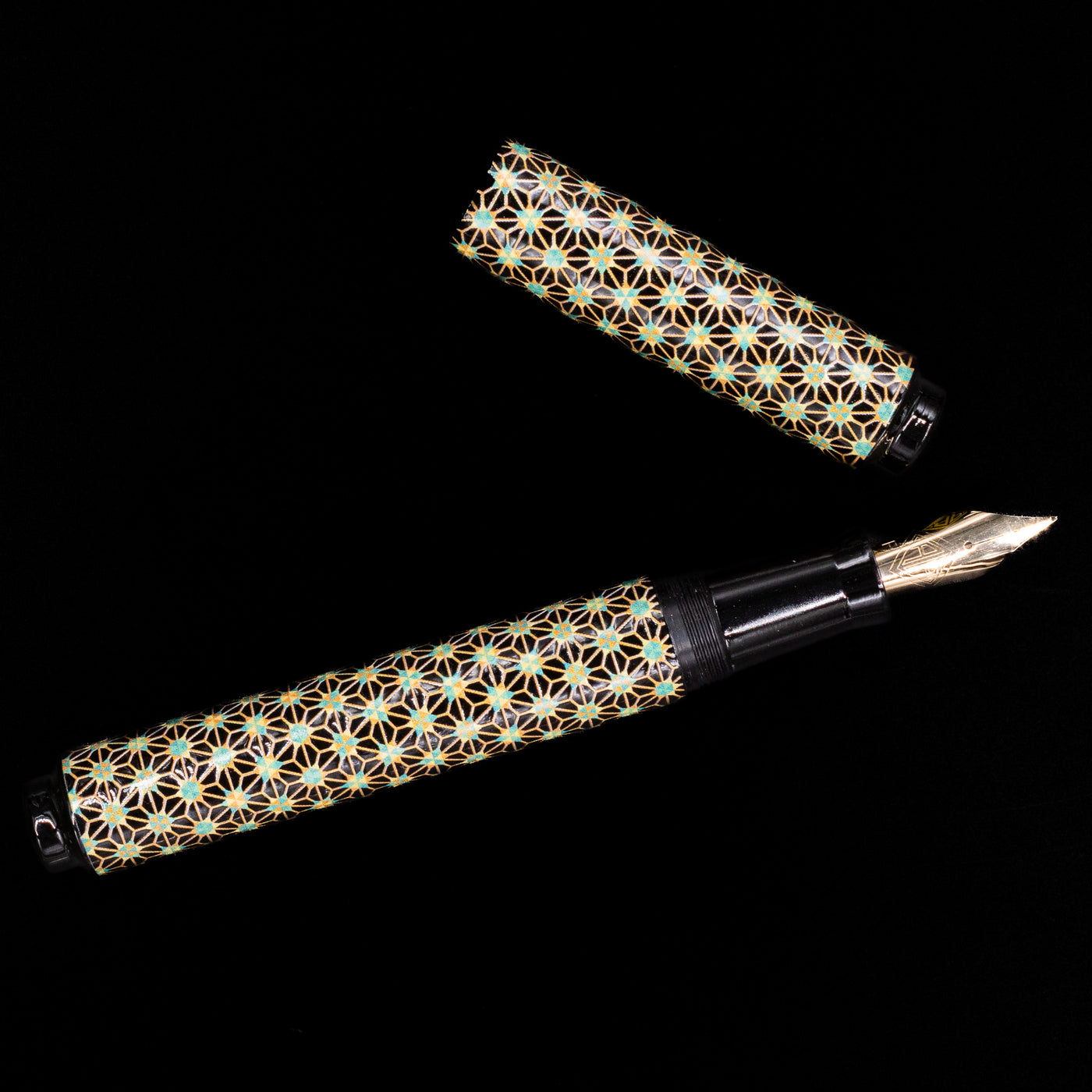 An overhead view of the AP Limited Editions Sakura Lacquer Art Fountain Pen - Teal Stars uncapped.