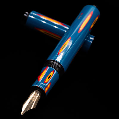 AP Limited Editions Urushi Lacquer Art Fountain Pen - Amorphous Splendour laying across its own cap, crossed, with a focus on the nib.