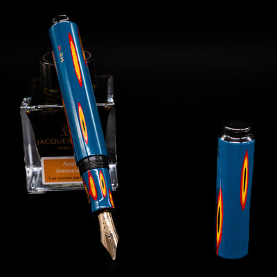 AP Limited Editions Urushi Lacquer Art Fountain Pen - Amorphous Splendour leaning on an ink bottle uncapped showcasing the detailing on the nib.
