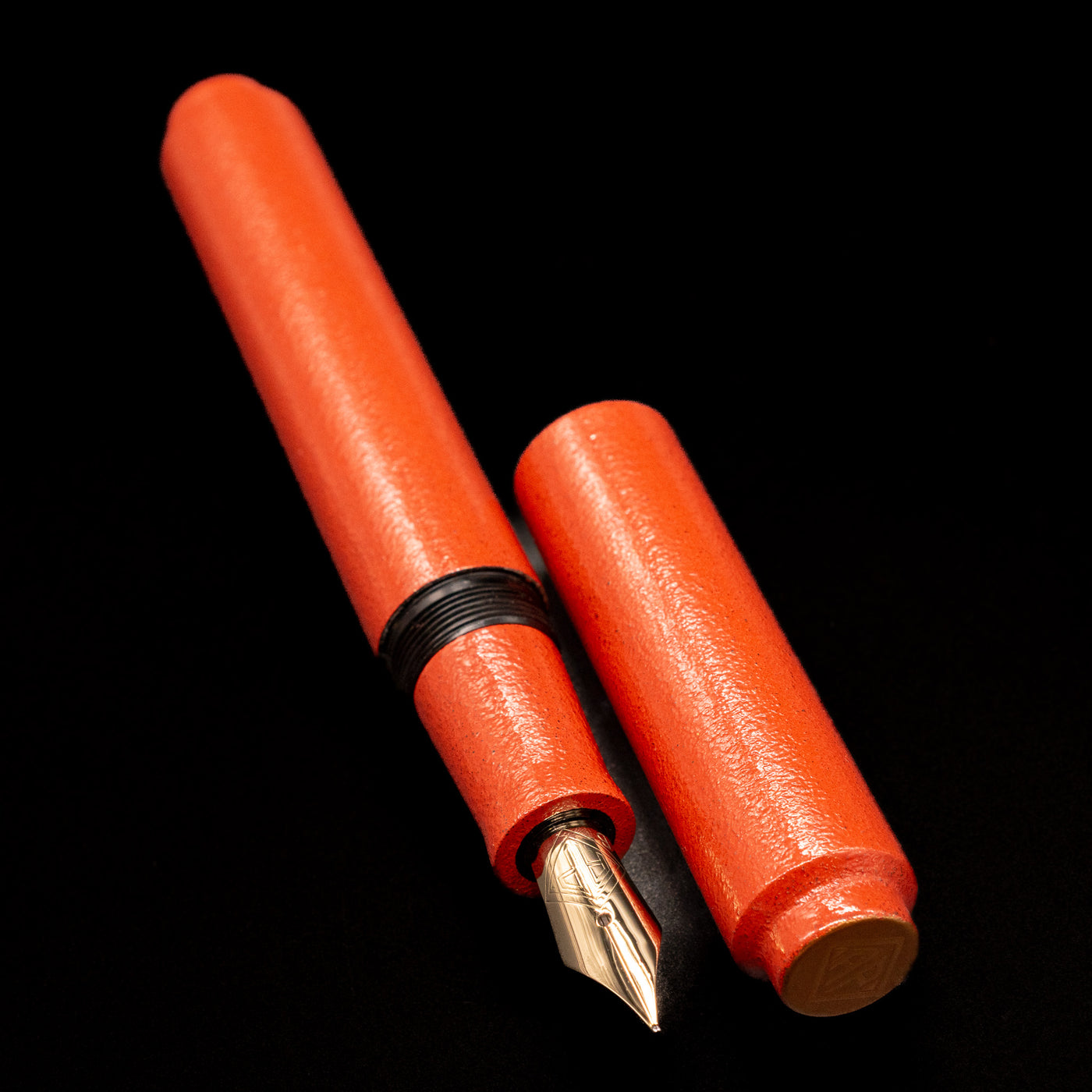 A full view of the AP Limited Editions Urushi Lacquer Art Fountain Pen - Colors of the Cosmos Aldebaran uncapped, with its cap laying next to the pen. 