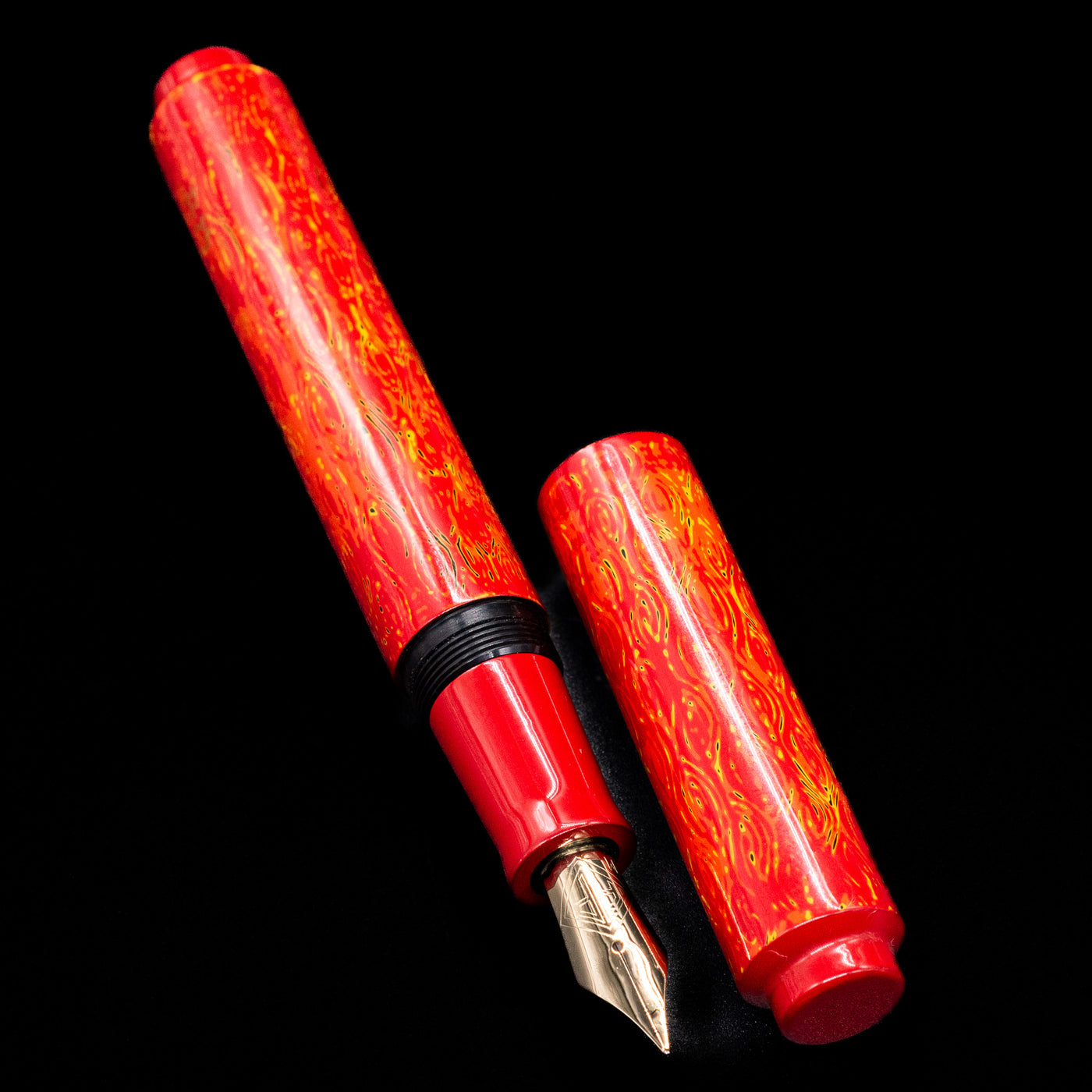 A full view of the AP Limited Editions Urushi Lacquer Art Fountain Pen - Red Earth uncapped, with its cap laying next to the pen. 