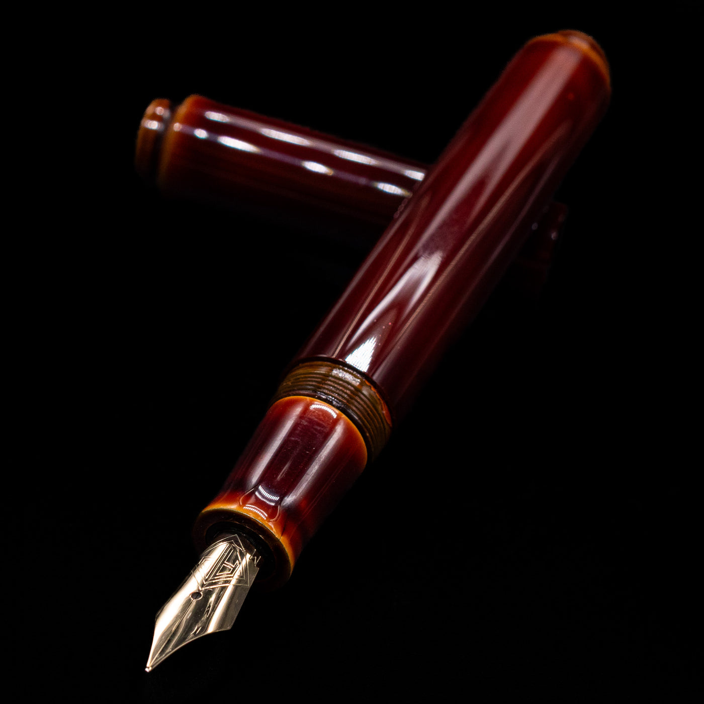 AP Limited Editions Urushi Lacquer Art Fountain Pen - Tamenuri Yellow leaning on an ink bottle uncapped showcasing the detailing on the nib.