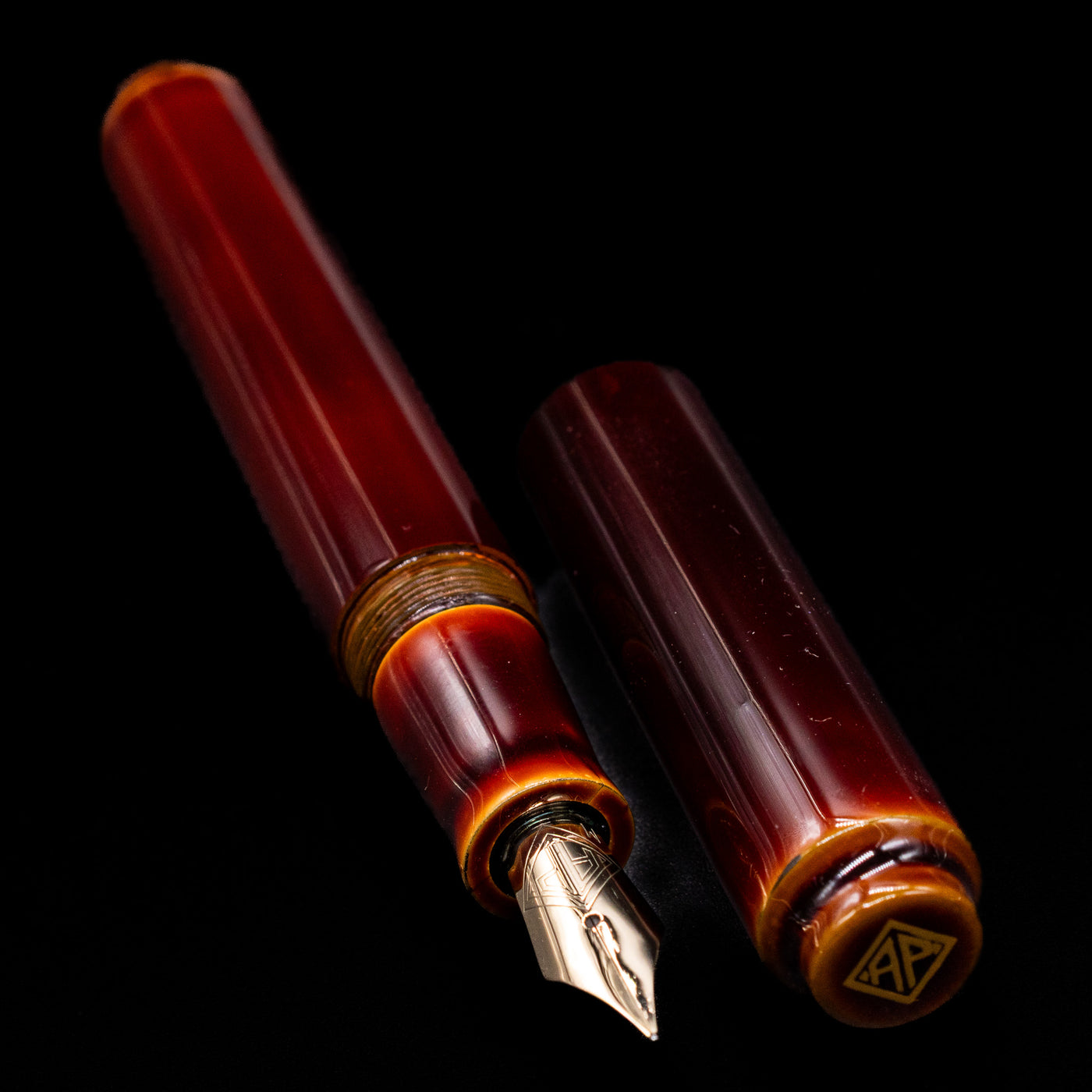 A full view of the AP Limited Editions Urushi Lacquer Art Fountain Pen - Tamenuri Yellow uncapped, with its cap laying next to the pen. 