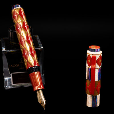 AP Limited Editions Writer Maki-e Fountain Pen - Aogai Deco leaning on an ink bottle uncapped showcasing the detailing on the nib.