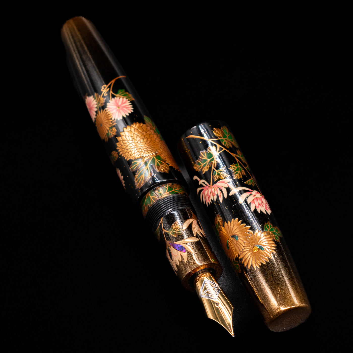  A full view of the AP Limited Editions Writer Maki-e Fountain Pen - Chrystanthemum (Prototype) uncapped, with its cap laying next to the pen.
