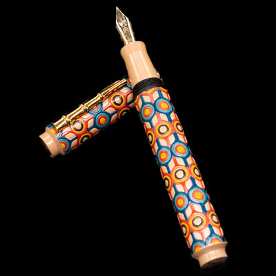 AP Limited Editions Writer Maki-e Fountain Pen - Orbit laying on top of its cap in a crossed position showing full view of the entire uncapped pen.