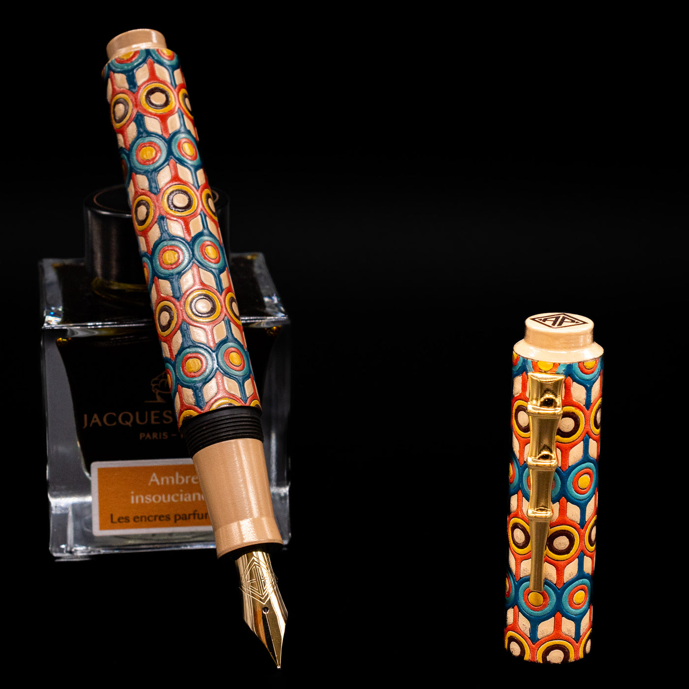AP Limited Editions Writer Maki-e Fountain Pen - Orbit leaning on an ink bottle uncapped showcasing the detailing on the nib.