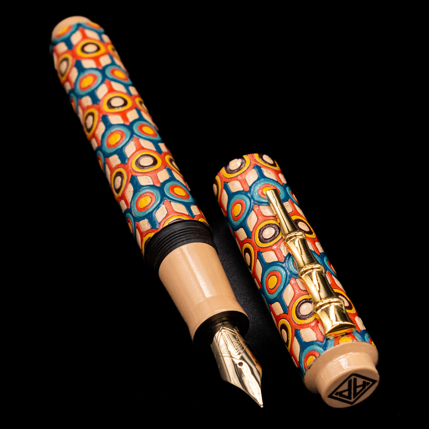 A full view of the AP Limited Editions Writer Maki-e Fountain Pen - Orbit uncapped, with its cap laying next to the pen. 