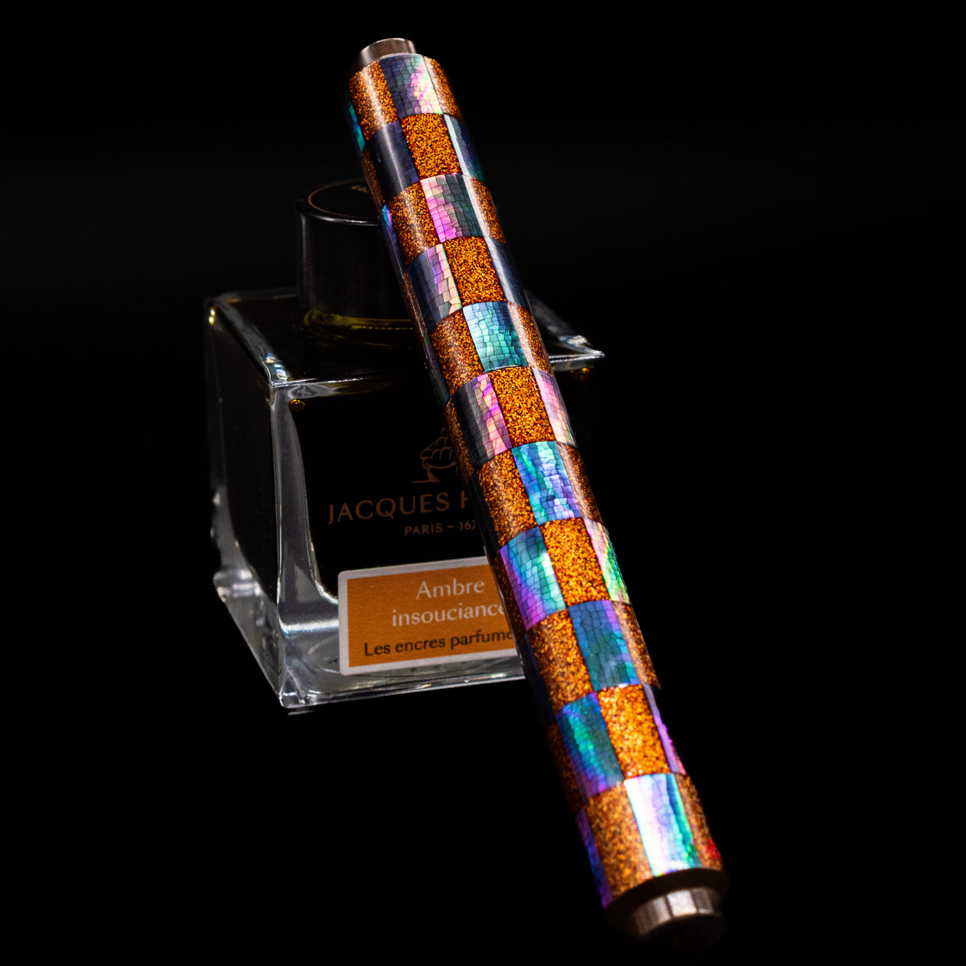 AP Limited Editions Writer Maki-e Fountain Pen - Sparkle capped, leaning against an ink bottle. 