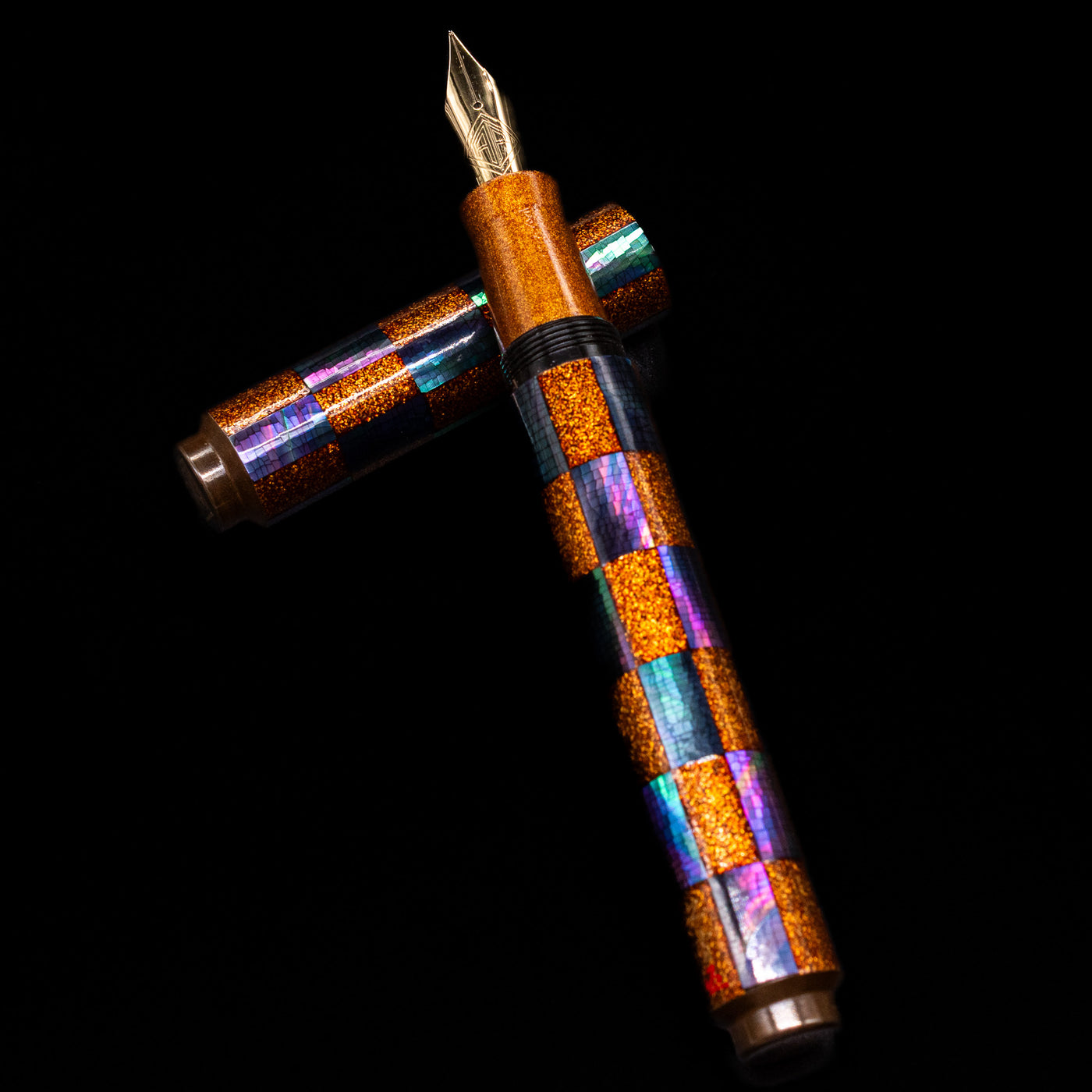 AP Limited Editions Writer Maki-e Fountain Pen - Sparkle laying on top of its cap in a crossed position showing full view of the entire uncapped pen.