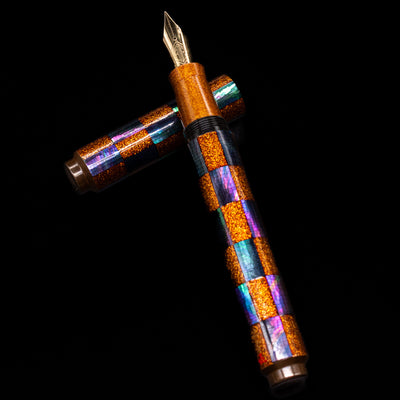 AP Limited Editions Writer Maki-e Fountain Pen - Sparkle laying on top of its cap in a crossed position showing full view of the entire uncapped pen.