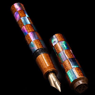  A full view of the AP Limited Editions Writer Maki-e Fountain Pen - Sparkle uncapped, with its cap laying next to the pen. 
