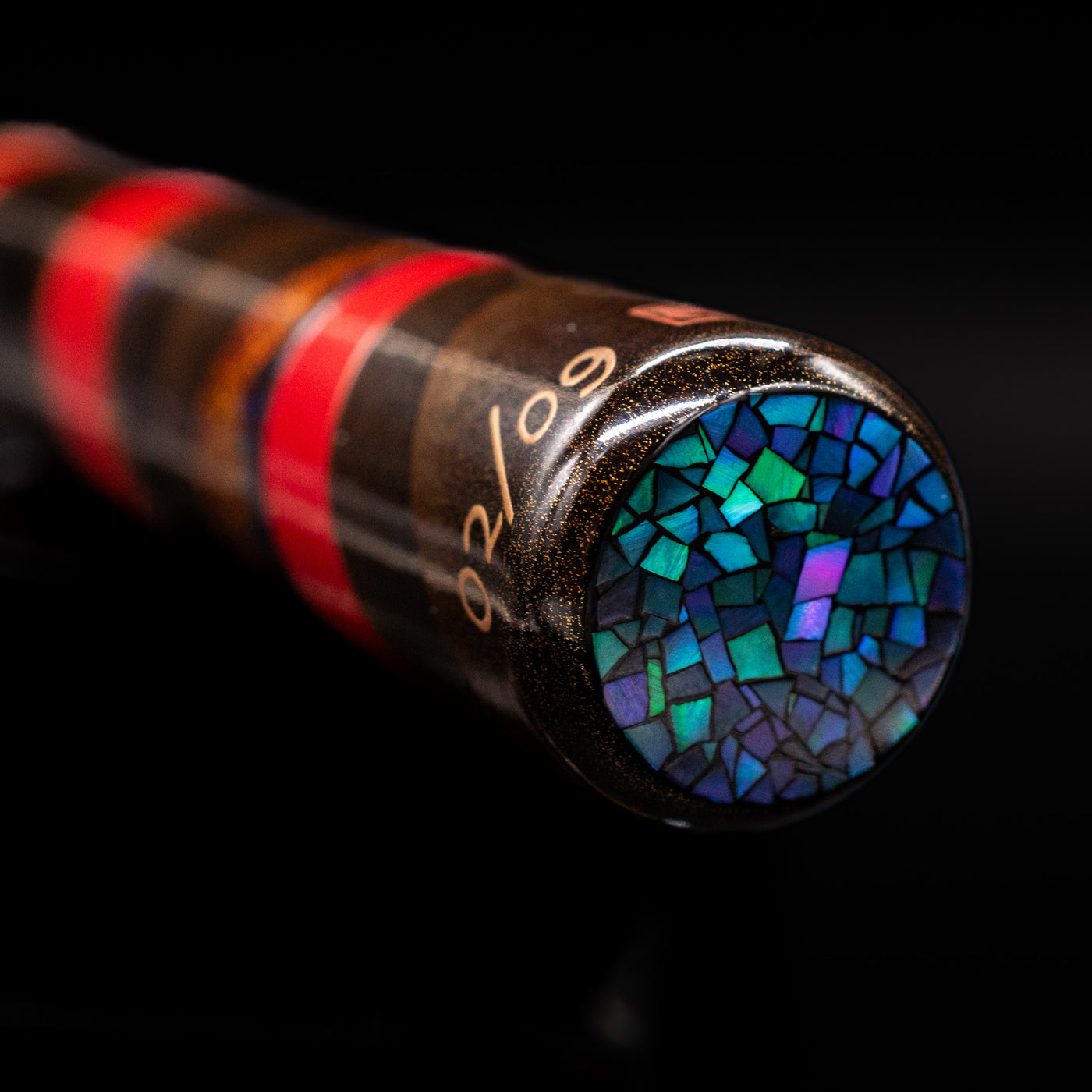 A zoomed-in view of the bottom of the AP Limited Editions Writer Maki-e Fountain Pen - The Dunes showcasing its raden pieces.