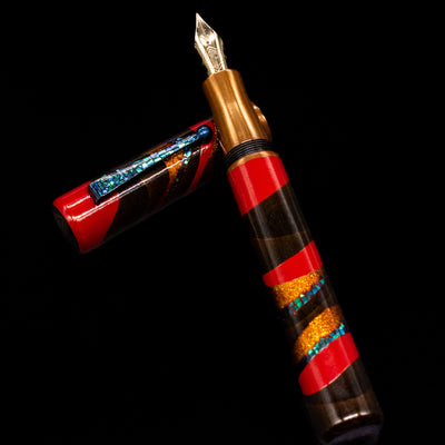 AP Limited Editions Writer Maki-e Fountain Pen - The Dunes laying on top of its cap in a crossed position showing full view of the entire uncapped pen.