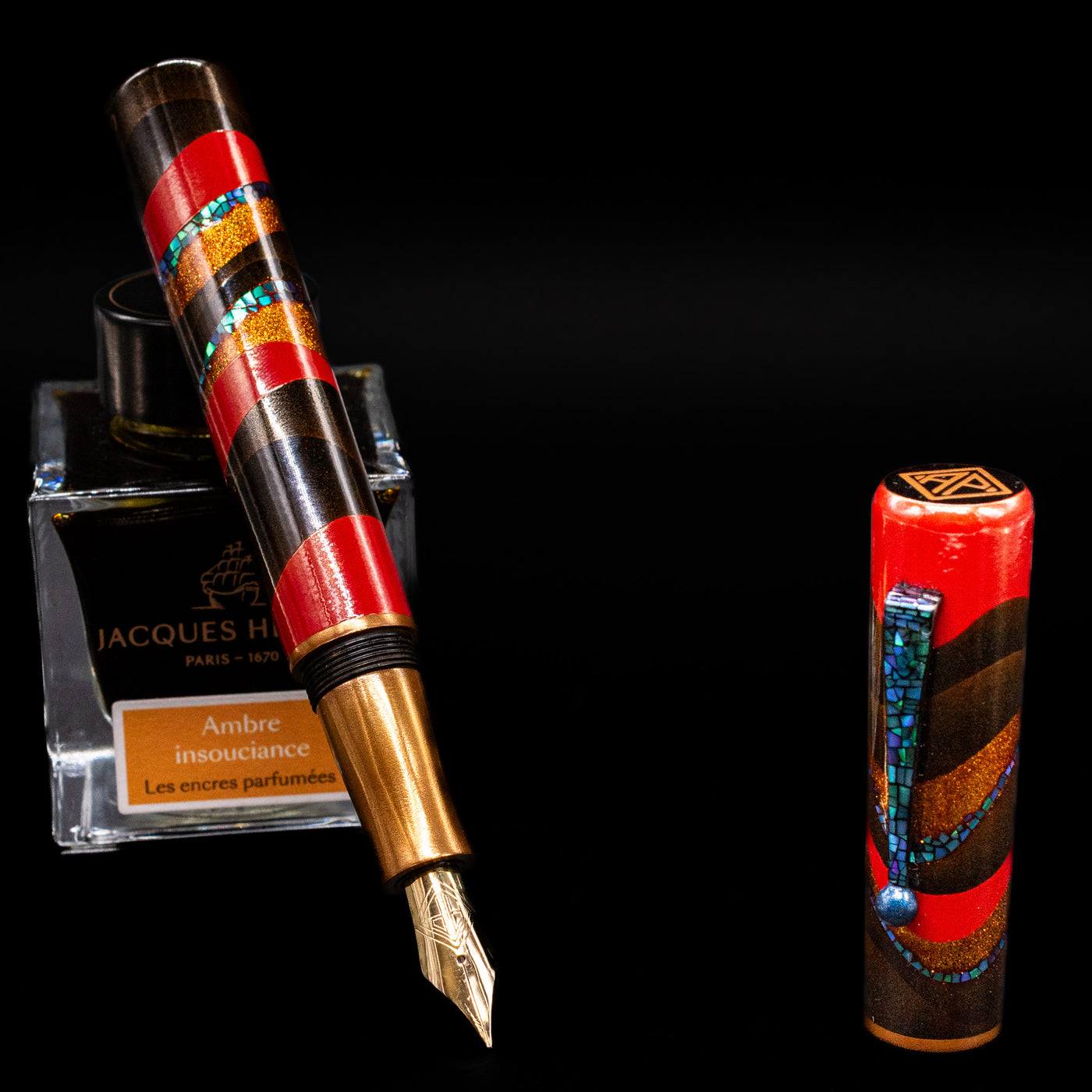 AP Limited Editions Writer Maki-e Fountain Pen - The Dunes leaning on an ink bottle uncapped showcasing the detailing on the nib.