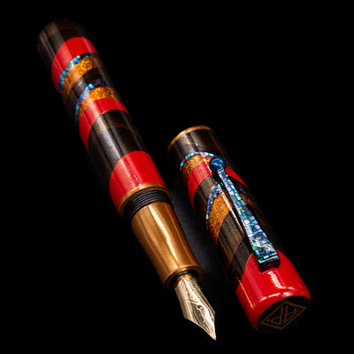 A full view of the AP Limited Editions Writer Maki-e Fountain Pen - The Dunes uncapped, with its cap laying next to the pen. 