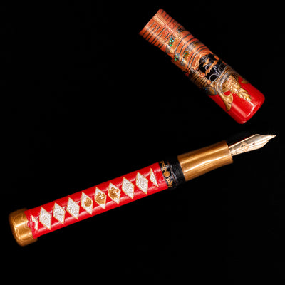 An overhead view of the AP Limited Editions Writer Maki-e Fountain Pen - The Pride of Samurai uncapped.
