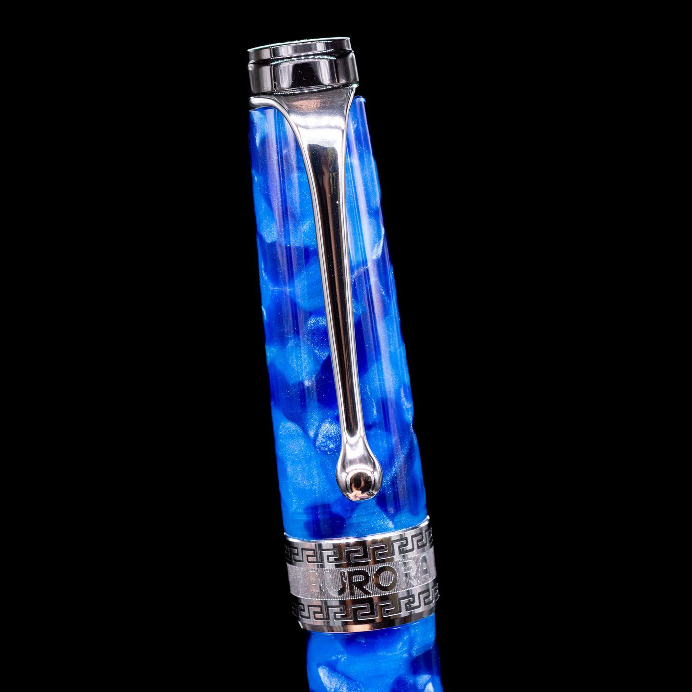 Close-up of the cap and clip of the Aurora Optima Auroloide Blue & Chrome fountain pen, highlighting the polished rhodium-plated clip, decorative engraved cap band, and the rich marbled blue resin finish.