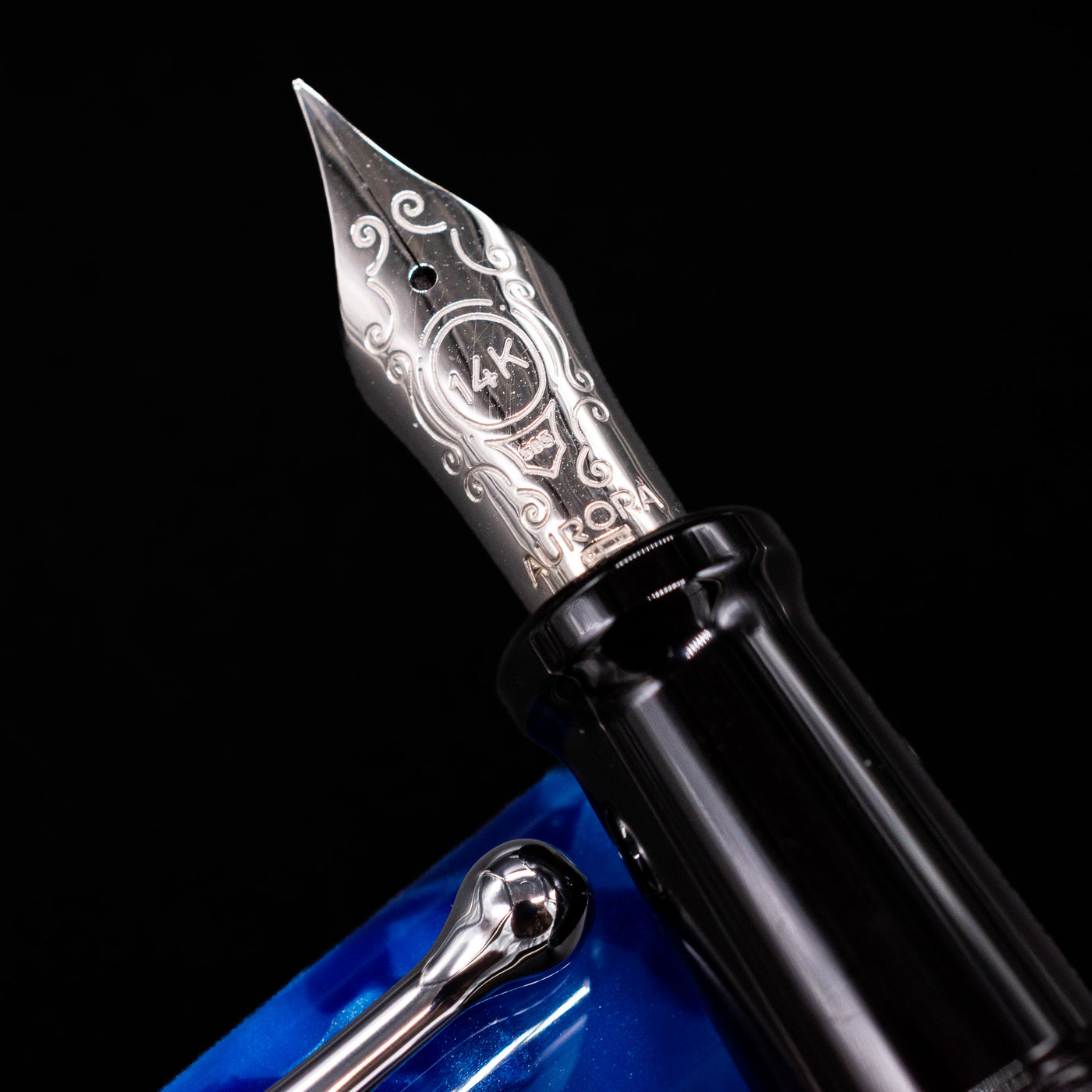 Close-up of the rhodium-plated 14k gold nib on the Aurora Optima Auroloide Blue & Chrome fountain pen, showing fine engravings and the Aurora logo.