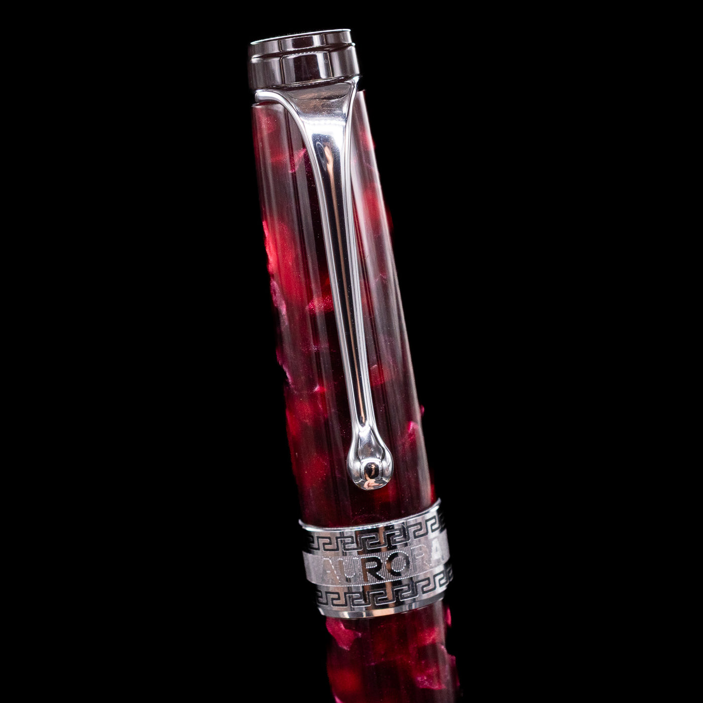 Close-up of the cap and clip of the Aurora Optima Auroloide Burgundy fountain pen, highlighting the polished rhodium-plated clip, decorative engraved cap band, and the rich marbled burgundy resin finish.