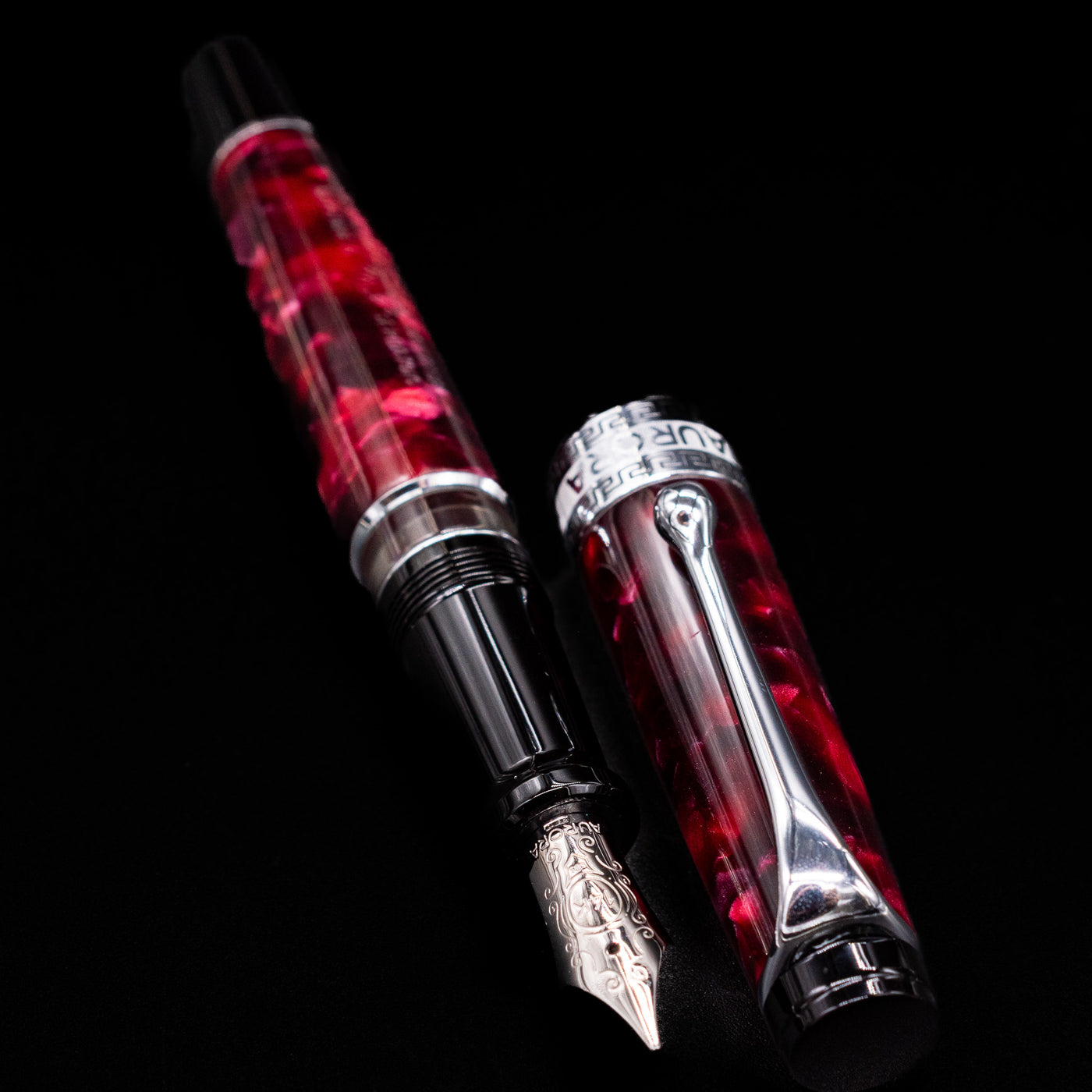 Aurora Optima Auroloide Burgundy fountain pen displayed uncapped, revealing the marbled burgundy resin barrel, grip section, and engraved silver nib.