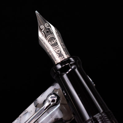 Close-up of the rhodium-plated 14k gold nib on the Aurora Optima Auroloide Nero Perla fountain pen, showing fine engravings and the Aurora logo.