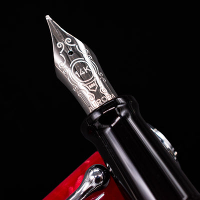 Close-up of the rhodium-plated 14k nib on the Aurora Optima Auroloide Rossa fountain pen, showing fine engravings and the Aurora logo.