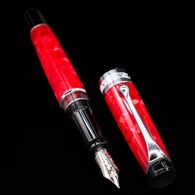 Aurora Optima Auroloide Rossa fountain pen displayed uncapped, revealing the marbled red resin barrel, grip section, and engraved 14K gold nib.