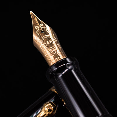 Close-up of the gold 14k nib on the Aurora Optima O Sole Mio fountain pen, showing fine engravings and the Aurora logo.