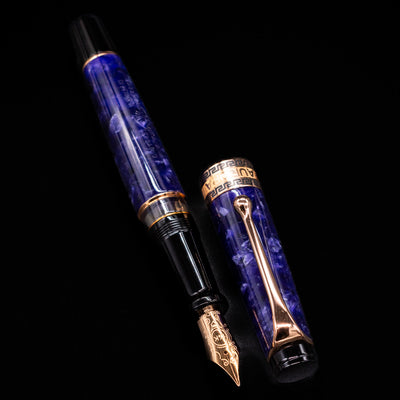 Aurora Optima Viola fountain pen displayed uncapped, revealing the marbled purple resin barrel, rhodium-plated grip section, and engraved rose gold nib.
