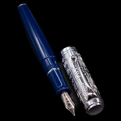 A full view of the Aurora Talentum Dedalo Blue Fountain Pen - Preowned uncapped, with its cap laying next to the pen. 