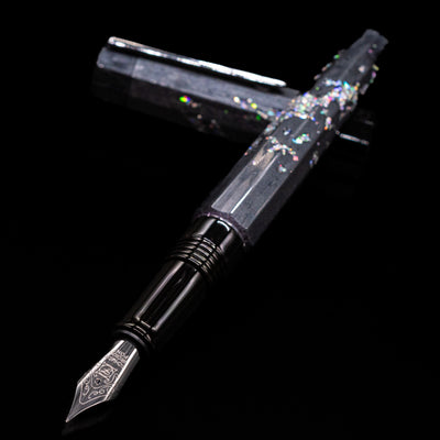 BENU Euphoria Caviar Fountain Pen laying across its own cap, crossed, with a focus on the nib.