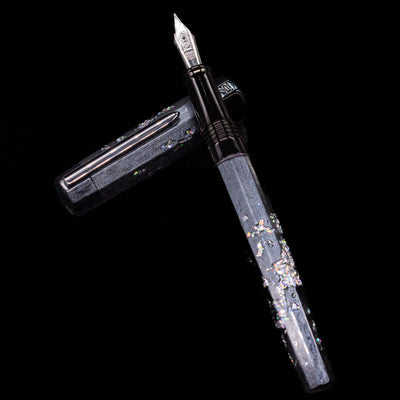 BENU Euphoria Caviar Fountain Pen laying on top of its cap in a crossed position showing full view of the entire uncapped pen.